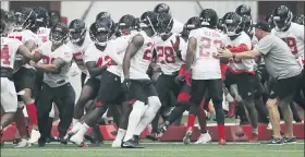  ?? ASSOCIATED PRESS FILE PHOTOS ?? The Atlanta Falcons defensive unit runs an agility drill at the NFL football team’s practice facility in Flowery Branch, Ga.