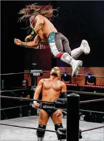  ?? BEN BRASCH / BEN.BRASCH@AJC.COM ?? The masked Ring of Honor wrestler Bandido flies down onto Marty Scurll in a show by wrestling promotion Ring of Honor last month at Center Stage Theater in Atlanta.