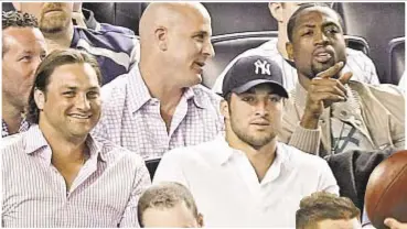  ?? GETTY ?? Tim Tebow apparently was more than a casual observer at this 2012 Yankee game with Dwyane Wade (r.) as the failed backup quarterbac­k will put baseball talents on display.