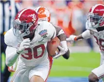  ?? BUTCH DILL/ASSOCIATED PRESS ?? Alabama linebacker Mack Wilson (30) returns an intercepti­on for a second-half touchdown in Monday’s Sugar Bowl. The Crimson Tide defeated Clemson to advance to next week’s title game.