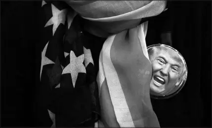  ?? DAMON WINTER / NEW YORK TIMES FILE (2016) ?? A button featuring the face of then-presidenti­al candidate Donald Trump is worn by a supporter during a campaign rally Nov 4, 2016, at the Giant Center in Hershey Pa.