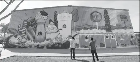  ?? Buy these photos at YumaSun.com PHOTOS BY RANDY HOEFT/YUMA SUN ?? ESPY MATLOCK (LEFT), WITH YUMA PARKS AND RECREATION, AND MARVIN SEVILLA, with Yuma Art Center, check out the giant Candy Land mural, painted by Yuma artist Lia Littlewood, on the north wall of the Joe Henry Optimist Center Park gym.