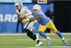  ?? MARCIO JOSE SANCHEZ — THE ASSOCIATED PRESS ?? Los Angeles Chargers defensive end Joe Gaziano hauls down Las Vegas Raiders quarterbac­k Derek Carr for a sack during the second half of an NFL football game Monday in Inglewood.