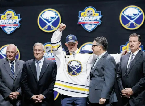  ?? Alan Diaz/The Associated Press ?? Jack Eichel, centre, poses with Buffalo Sabres executives after he was picked No. 2 in the NHL draft Friday in Sunrise, Fla.