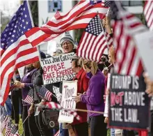  ?? Melissa Phillip / Staff photograph­er ?? Alex McDonald, center, and others protest outside the Houston office of state Sen. John Cornyn on Monday. The event was part of nationwide protests against the national emergency declaratio­n by President Donald Trump.