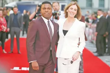  ??  ?? British actor John Boyega (left) and director Bigelow pose for a photograph upon arrival at the European premiere of ‘Detroit’ in London on Wednesday. (Below left to right) British actors Will Poulter, Hannah Murray and US actor Jack Reynor arrive at...