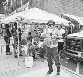  ?? CRAIG LASSIG/AP ?? Volunteers work at a medical station last week near the location where George Floyd died earlier this year while in police custody in Minneapoli­s.