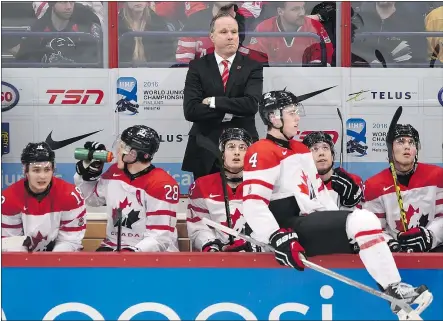  ?? — CP ?? Head coach Dave Lowry, at back, avoided most of the blame from Hockey Canada president Tom Renney over the country’s world junior finish, as Renney instead cited a lack of ‘maturity’ from the players.