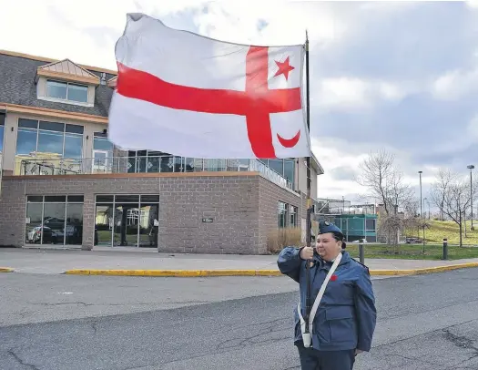  ?? CADET WARRANT OFFICER 2ND CLASS CHARLIE CHAFE ?? Cadet Warrant Officer 2nd Class Jolie Jedorre marches with the Mi'kmaw flag as she takes part in a Remembranc­e Day ceremony. Jedorre lives on reserve in Eskasoni and will be leading her Royal Canadian
Air Cadet Squadron 29 Sydney Kiwanis at the ceremony in Membertou Nov. 11.