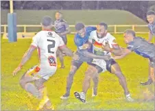  ?? Picture: REINAL CHAND ?? The Kaiviti Silktails defence works hard to stop PNG Hunters player Sakias Komati during their match in the Melanesian Bowl Challenge at Lawaqa Park in Sigatoka on Saturday night.