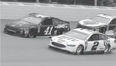  ?? AP Photo/Carlos Osorio ?? ■ Kurt Busch (41) and Brad Keselowski (2) lead the field at the start of a NASCAR Cup Series race Sunday in Brooklyn, Mich.