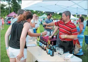  ?? FILE PHOTO ?? Event-goers sample Corinth-based Ledge Rock Hill Winery and Vineyards wine products at the 2016 Adirondack Wine & Food Festival.