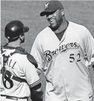  ?? AP ?? Brewers pitcher CC Sabathia celebrates with catcher Jason Kendall after Sabathia threw a complete game one-hitter against the Pittsburgh Pirates.