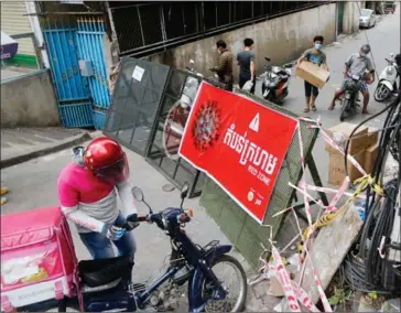  ?? HENG CHIVOAN ?? Electricit­y boxs are seen at a red zone in Phnom Penh’s Meanchey district.