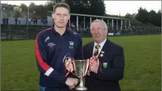  ??  ?? County Chairman Martin Coleman presents Glenealy Senior hurling captain Danny Staunton with the Kavanagh Cup for winning the league.