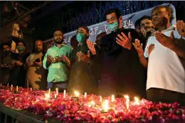  ?? AP Photo/Fareed Khan ?? People attend a candleligh­t vigil Friday for victims of the crash of a state-run Pakistan Internatio­nal Airlines plane that crashed Wednesday.