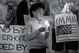  ?? CHELSEA PURGAHN/TYLER MORNING TELEGRAPH VIA AP ?? MEZEKIR KNIGHT, 8, PRAYS DURING A VIGIL IN SUPPORT of immigrants and refugees at T.B. Butler Fountain Plaza in Tyler, Texas, last week.