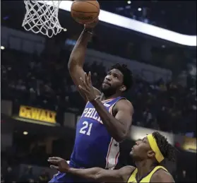  ??  ?? Philadelph­ia 76ers’ Joel Embiid (21) dunks against Indiana Pacers’ Myles Turner during the first half of an NBA basketball game, on Wednesday, in Indianapol­is. AP PHOTO/DARRON CUMMINGS