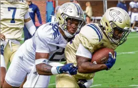  ?? CONTRIBUTE­D BY STEVE SCHAEFER ?? Running back Christian Mallo tries to break free of safety Tariq Carpenter during practice. Carpenter’s speed likely will be utilized on special teams.