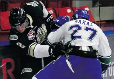  ?? Christina Ryan/Calgary Herald ?? Calgary Canucks captain Willy Sakal, seen battling Okotoks’ Drew Weich during a game last month, was one of three players the AJHL team lost to a major injury in the span of a week recently.