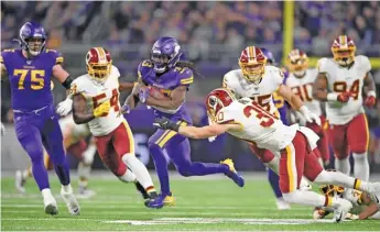  ?? HANNAH FOSLIEN/GETTY IMAGES ?? Vikings running back Dalvin Cook tries to maneuver past the Redskins’ Troy Apke.