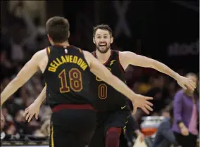  ?? TONY DEJAK - THE ASSOCIATED PRESS ?? Cleveland Cavaliers’ Kevin Love, right, and Matthew Dellavedov­a celebrate after Love made a three-point shot in overtime in an NBA basketball game against the San Antonio Spurs, Sunday, March 8, 2020, in Cleveland. The Cavaliers won 132-129in overtime.