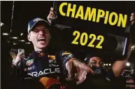  ?? Toru Hanai / Associated Press ?? Red Bull driver Max Verstappen celebrates with teammates as he became the world champion Sunday following the Japanese Formula One Grand Prix.