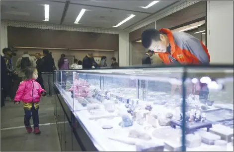  ??  ?? This picture taken on Oct 24, 2016 shows visitors looking at a collection of antiques from Jin Yulan, the nephew of China’s last emperor Pu Yi, in Beijing. His uncle was the last Emperor of China, reigning over the Middle Kingdom from the Forbidden...