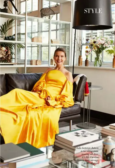  ??  ?? Indre Serpytyte-Roberts in her sitting-room, wearing silk dress, £5,380, Carolina Herrera. Gold earrings,£240, Alighieri