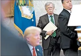  ?? ANDREW HARRER/BLOOMBERG NEWS ?? John Bolton, center, spooked North Korea recently by suggesting it follow the path of Libya more than a decade ago when that country abandoned its nuclear weapons effort.