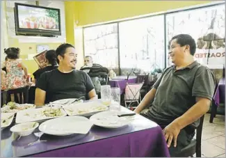  ??  ?? THE PAINTER, left, chatting with Intiraymi owner Fabián Nahui during a recent lunch, says the modest restaurant is the closest thing to an Andean truck stop one could find in Los Angeles.