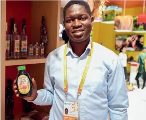  ?? ?? An exhibitor presents a honey product from Uganda at the sixth CIIE in Shanghai on 8 November