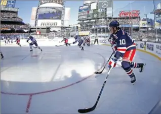  ?? ADAM HUNGER, THE ASSOCIATED PRESS ?? New York Rangers left wing Jonathan (J.T.) Miller controls the puck against the Buffalo Sabres in the first period of the NHL Winter Classic hockey game at CitiField in New York on Monday. The Rangers won 3-2 in overtime.