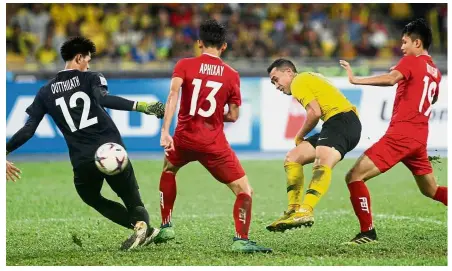  ?? — FAIHAN GHANI / The Star ?? Goal!: Malaysia’s Norshahrul Idlan Talaha (second from right) scoring a goal in the AFF Suzuki Cup match against Laos at the National Stadium in Bukit Jalil yesterday.