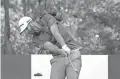  ?? CHARLES REX ARBOGAST/AP ?? Dustin Johnson hits his tee shot on the 16th hole Saturday during the third round of the BMW Championsh­ip in Olympia Fields, Ill. Johnson and Hideki Matsuyama were tied for the lead at 1-under after three rounds.