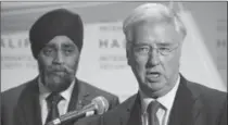  ?? DARREN CALABRESE, THE CANADIAN PRESS ?? Defence Minister Harjit Sajjan, left, looks on as British Defence Secretary Sir Michael Fallon speaks to reporters in Halifax on Friday.