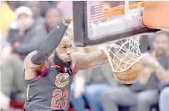  ??  ?? File photo shows LeBron James of the Cleveland Cavaliers dunks against the Golden State Warriors in the first quarter during Game Three of the 2018 NBA Finals at Quicken Loans Arena in Cleveland, Ohio. — AFP photo