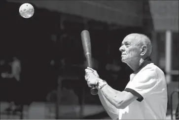  ?? Wally Skalij Los Angeles Times ?? RICHARD MACHINSKI swings at a Wiff le Ball in an exercise to help stir the memories of patients with Alzheimer’s disease and dementia. “It’s what we did when I was 8 years old,” he says. “It keeps you alive.”