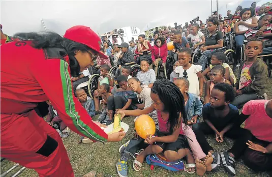  ?? Picture: SINO MAJANGAZA ?? ENOUGH FOR EVERYONE: EFF deputy general secretary Hlengiwe Hlophe hands out a slice of the party's massive cake to a pupil at Vukuhambe Special Needs School on Sunday. Hlophe was among her fellow officials which included Julius Malema and his wife who...