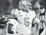  ?? Matt Cashore Associated Press ?? CLEMSON quarterbac­k D.J. Uiagalelei looks for a receiver during the first quarter against Notre Dame.