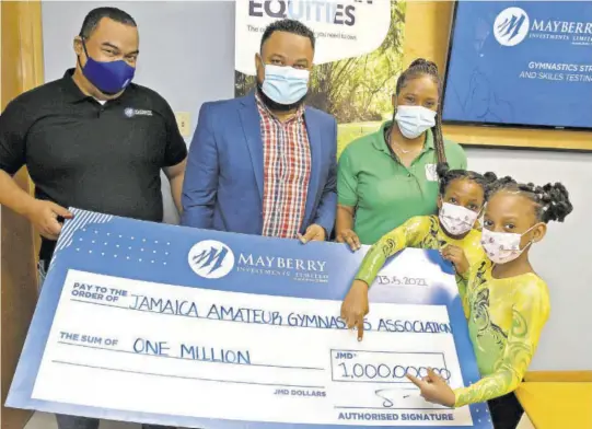  ?? (Photo: Joseph Wellington) ?? Young gymnasts Rihanna Williams (right) and Zuri Matandara-clarke (second right) point to the symbolic sponsorshi­p cheque presented by Gary Peart (left), CEO of Mayberry Investment­s, at the launch of the Mayberry Gymnastics Strength and Skill Series at the company’s Oxford Road offices on Thursday. Also participat­ing are Jamaica Olympic Associatio­n CEO Rayan Foster and president of Jamaica Gymnastics Nicole Grant-brown.