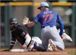  ?? ROSS D. FRANKLIN — THE ASSOCIATED PRESS, FILE ?? Cubs second baseman Matt Shaw (77) tags out the Giants' Luis Matos attempting to steal second base during the third inning of a spring game on Feb. 24in Scottsdale, Ariz.