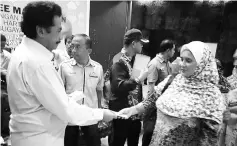  ??  ?? Ramlee presenting the contributi­on to the recipients at Majlis Tautan Kasih yesterday.