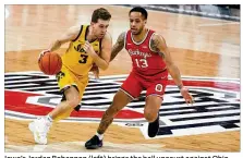 ?? JAY LAPRETE / AP ?? Iowa’s Jordan Bohannon (left) brings the ball upcourt against Ohio State’s C.J. Walker during Sunday’s clash in Columbus. The Buckeyes, who have lost three straight, host Illinois on Saturday.