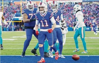 ?? Jeffrey T. Barnes/Associated Press ?? Buffalo Bills wide receiver Cole Beasley (11), center, celebrates his touchdown during the second half of an NFL wild-card playoff game against the Miami Dolphins on Jan. 15 in Orchard Park.