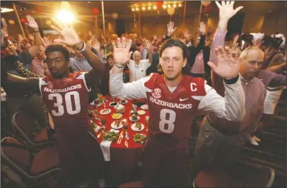  ?? NWA Democrat-Gazette/Andy Shupe ?? CALLING THE HOGS: Team captains Austin Allen (8) and Kevin Richardson II (30) call the Hogs Friday during the annual Kickoff Luncheon at the Northwest Arkansas Convention Center in Springdale. The Razorbacks open the season Thursday, Aug. 31 against...