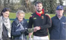  ?? ?? Ann Marie, Nora and Michael Walsh presenting the Mallow captain, Fionn O’Neill with the Tony Walsh Memorial Cup.