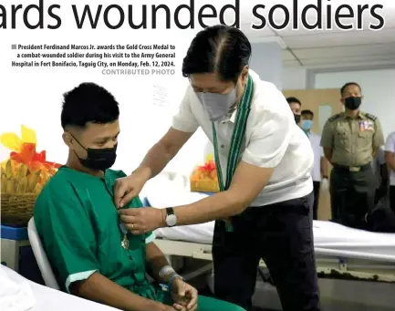  ?? CONTRIBUTE­D PHOTO ?? ■ President Ferdinand Marcos Jr. awards the Gold Cross Medal to a combat-wounded soldier during his visit to the Army General Hospital in Fort Bonifacio, Taguig City, on Monday, Feb. 12, 2024.