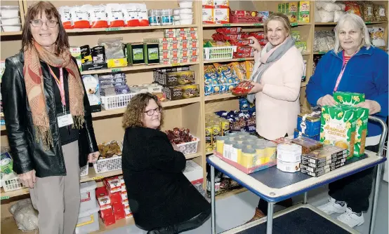  ?? Photograph: MICHAEL ROBINSON ?? Baw Baw Combined Churches Food Relief managers Anne Pascoe and Trish Addison (left) assist volunteers Jan Davidson and Anne Kuhnell to restock the pantry shelves after another busy week helping local families last week.