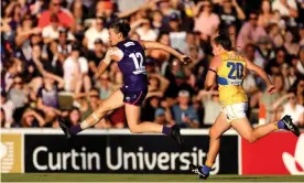  ?? Photograph: Richard Wainwright/AAP ?? Fremantle’s Ebony Antonio kicks one of her three goals during the Dockers’ win over West Coast Eagles in Perth.